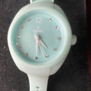 Stoolli ladies watch with soft plastic strap and sparkles around the face.